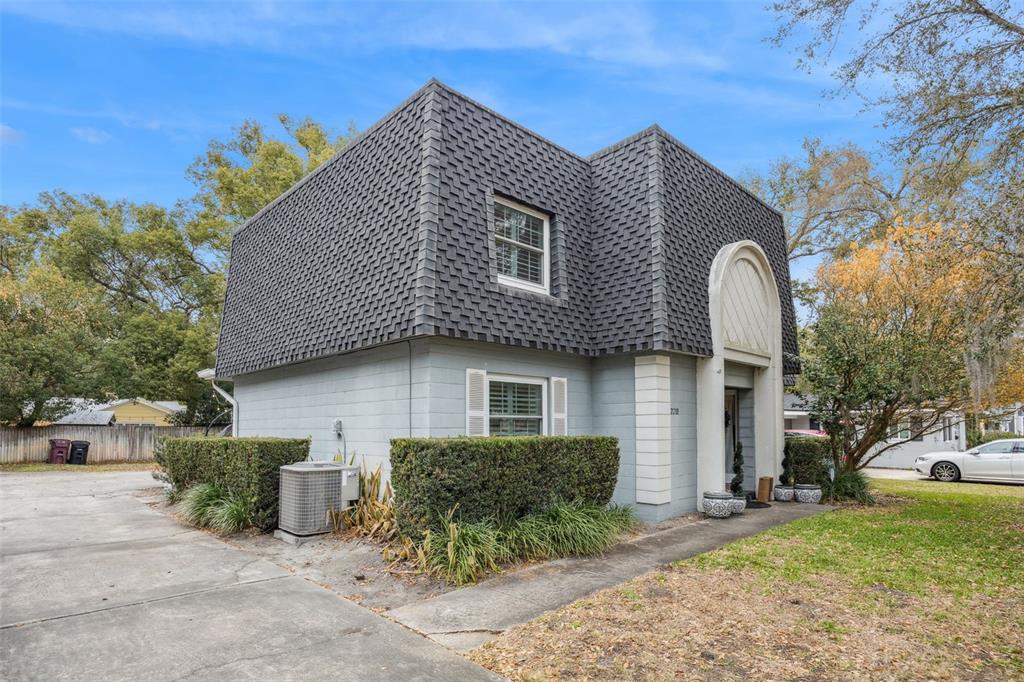 A two-story house with a mansard roof and a light gray concrete block exterior — 2218 ELIZABETH AVENUE UNIT 3, ORLANDO, FL