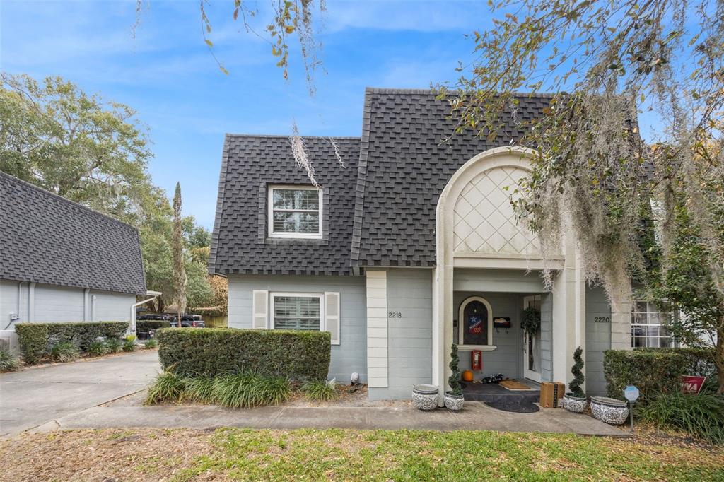 A two-story gray house with a dark shingled mansard roof and an arched entryway — 2218 ELIZABETH AVENUE UNIT 3, ORLANDO, FL