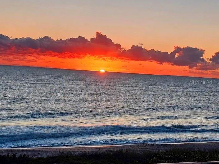 A vibrant sunset over the ocean with clouds above the horizon and a sandy beach — 5151 N HIGHWAY A1A UNIT 212, HUTCHINSON ISLAND, FL