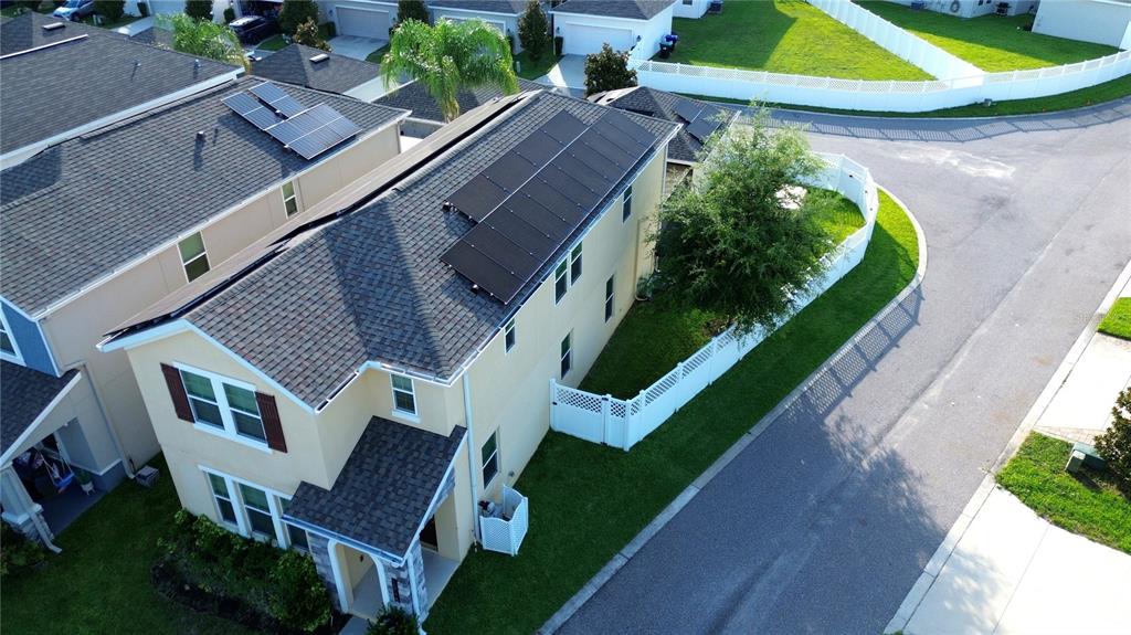 An aerial view shows a two-story house with solar panels on the roof — 15175 CHAPTER WAY, WINTER GARDEN, FL