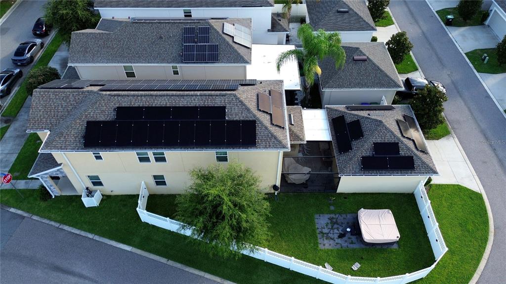 An aerial view shows a two-story house with solar panels on the roof and a backyard — 15175 CHAPTER WAY, WINTER GARDEN, FL