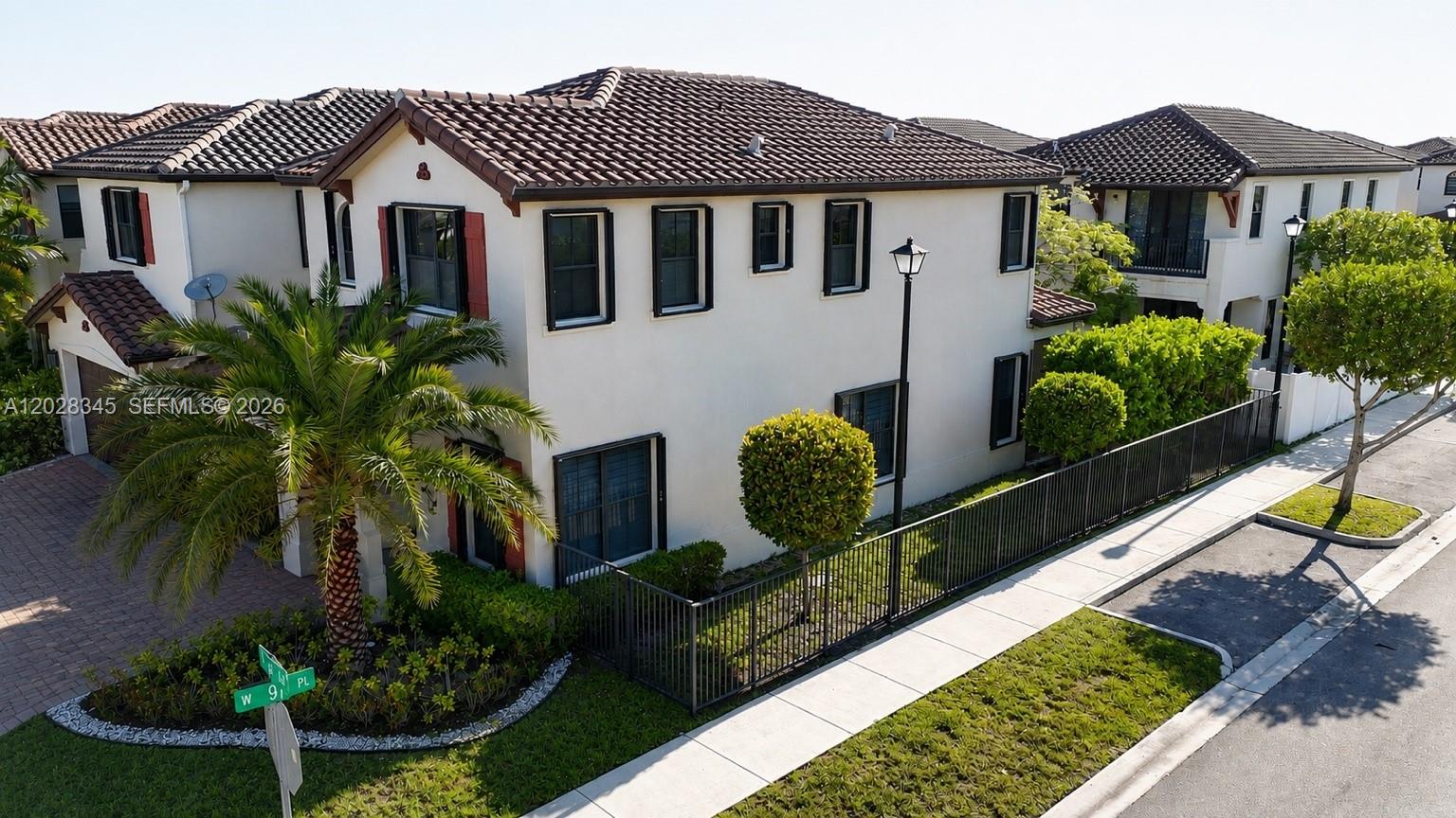 An aerial view shows a two-story stucco house with a tiled roof and fenced yard — 9717 W 34th Ln, Hialeah FL 33018, HIALEAH, FL
