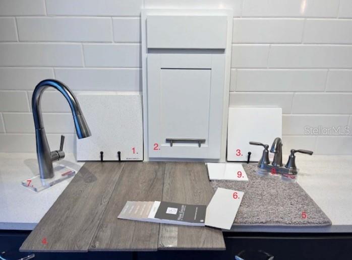 A display of interior design samples including cabinetry, flooring, countertop, and plumbing fixtures — 190 BLUE STAR COURT, TAVARES, FL