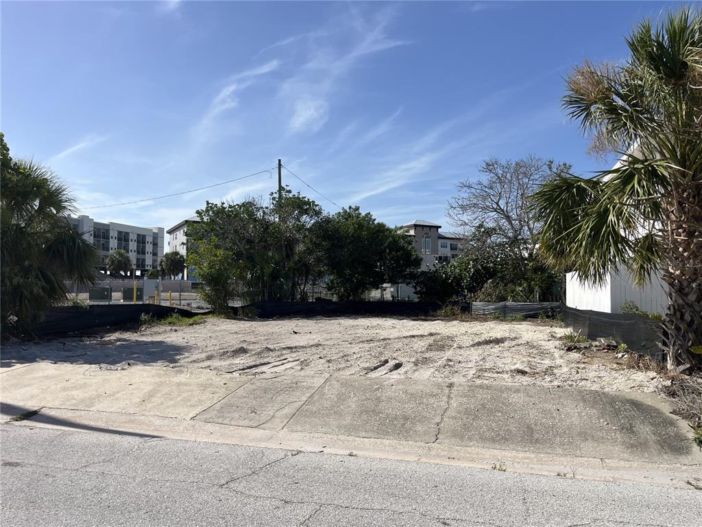 A vacant, sandy residential lot is enclosed by a black silt fence — 180 E MADEIRA AVENUE, MADEIRA BEACH, FL