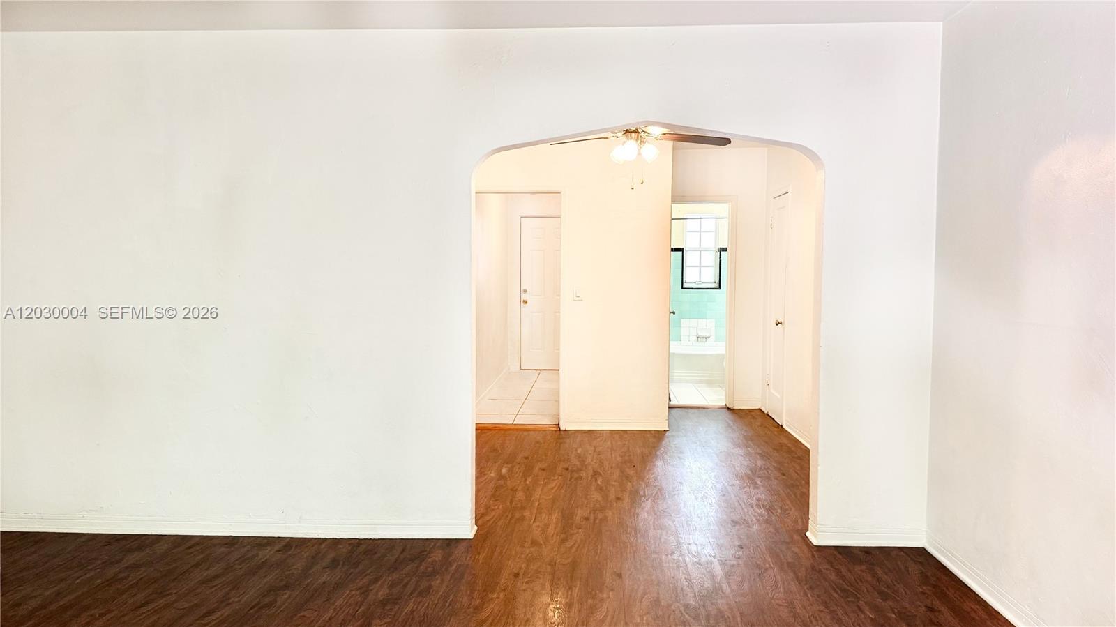 An arched doorway leads from a wood-floored room to a hallway with a bathroom — 4410 NE 2nd Ave # 4414, Miami FL 33137, MIAMI, FL
