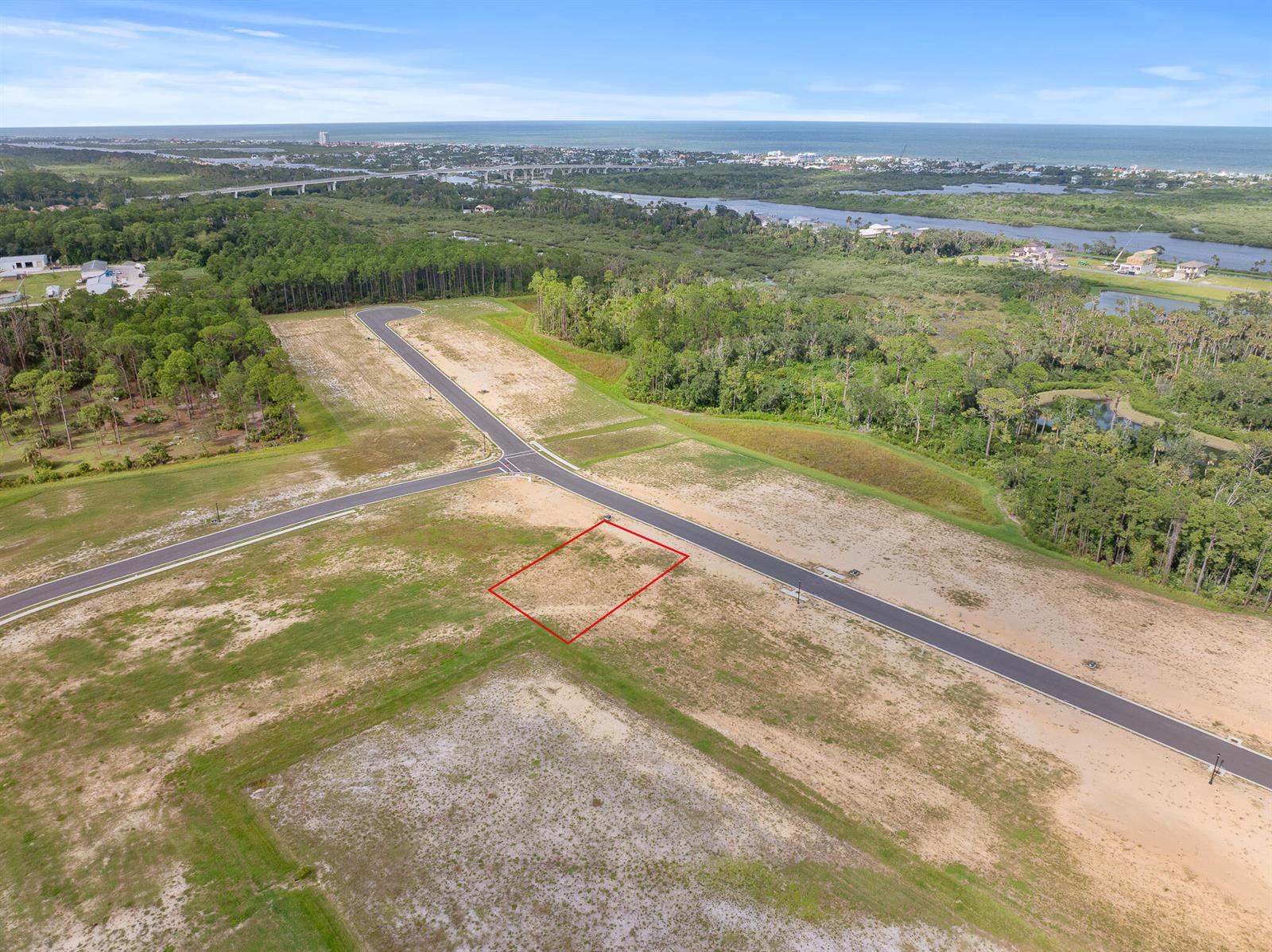 An aerial view shows a vacant residential lot outlined in red within a new subdivision — 217 Stillwater Drive, FL 32136, FL