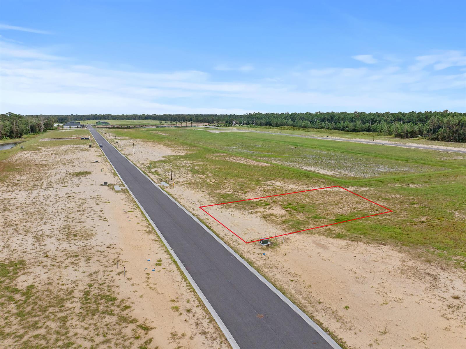 An aerial view shows a vacant residential lot outlined in red along a paved road — 217 Stillwater Drive, FL 32136, FL