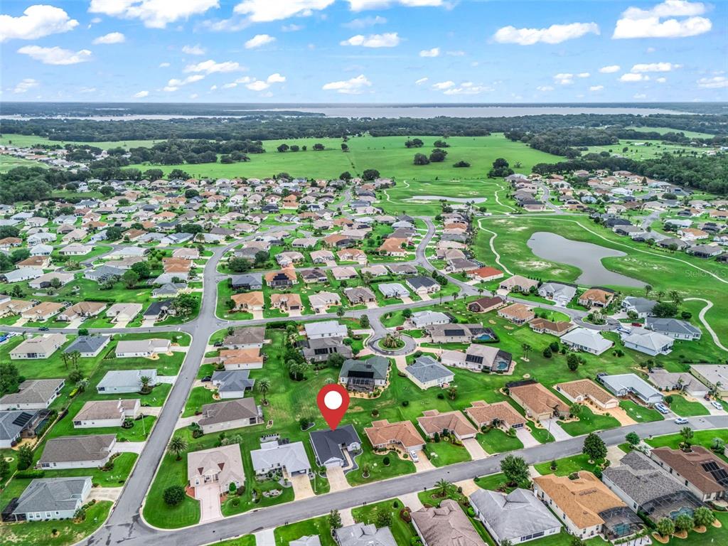 An aerial view shows a residential neighborhood with a marked house and nearby golf course — 12115 SE 176TH LOOP, SUMMERFIELD, FL