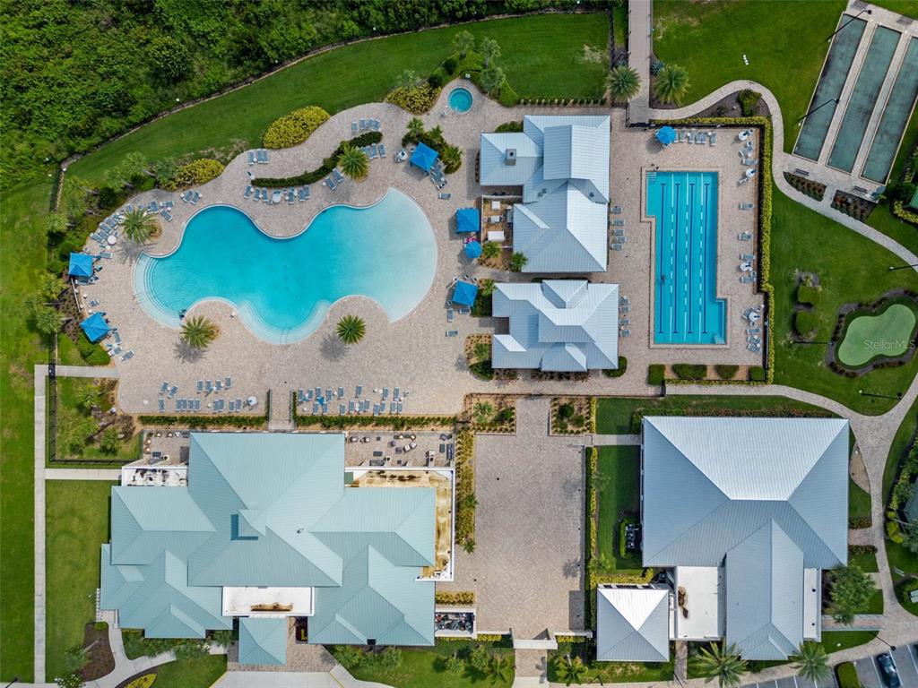 An aerial view shows a community clubhouse with two pools, a spa, and tennis courts — 2777 SOUTHLAND STREET, ST CLOUD, FL