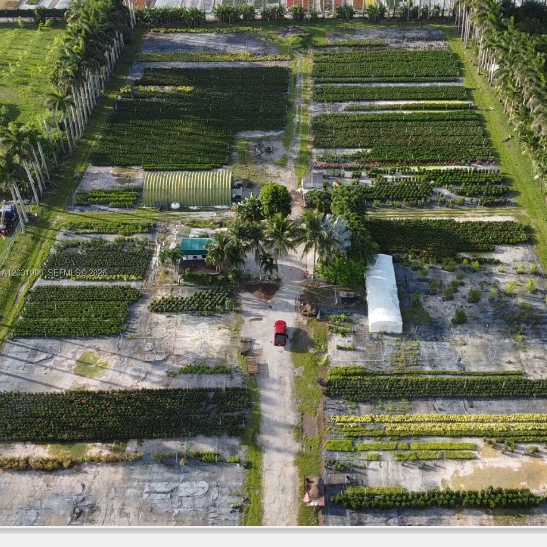An aerial view shows a plant nursery with rows of crops, greenhouses, and a red truck — 17001 SW 204th St, Miami FL 33187, MIAMI, FL