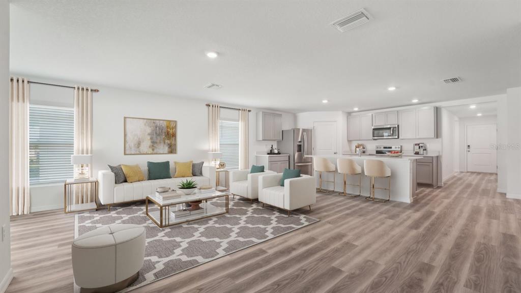 This is a digital rendering of an open-concept living room and kitchen with light flooring — 3512 HARVEST GARDENS LOOP, PLANT CITY, FL