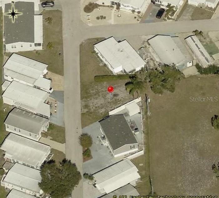 This aerial view shows a vacant residential lot marked with a red pin — 6509 NEW JERSEY STREET, BRADENTON, FL