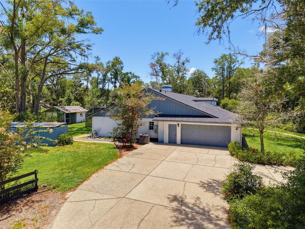 A single-story house with a blue and white exterior and a two-car garage — 15234 SCANIO, SPRING HILL, FL