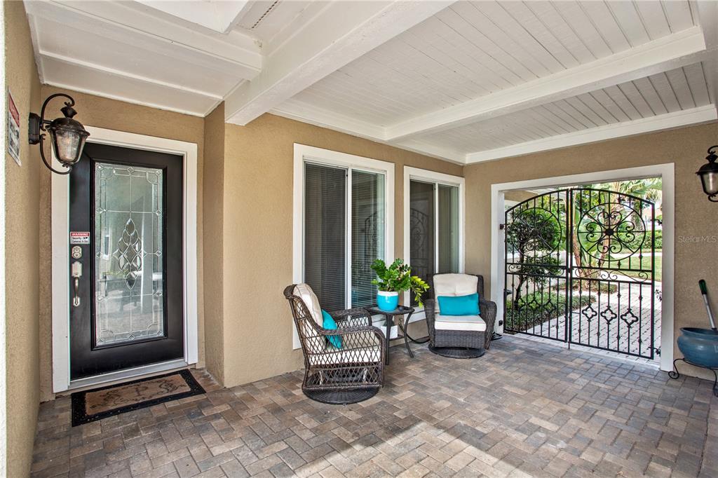 The exterior of a two-story house features a screened-in pool enclosure and a backyard swing — 4574 SAILBREEZE COURT, ORLANDO, FL