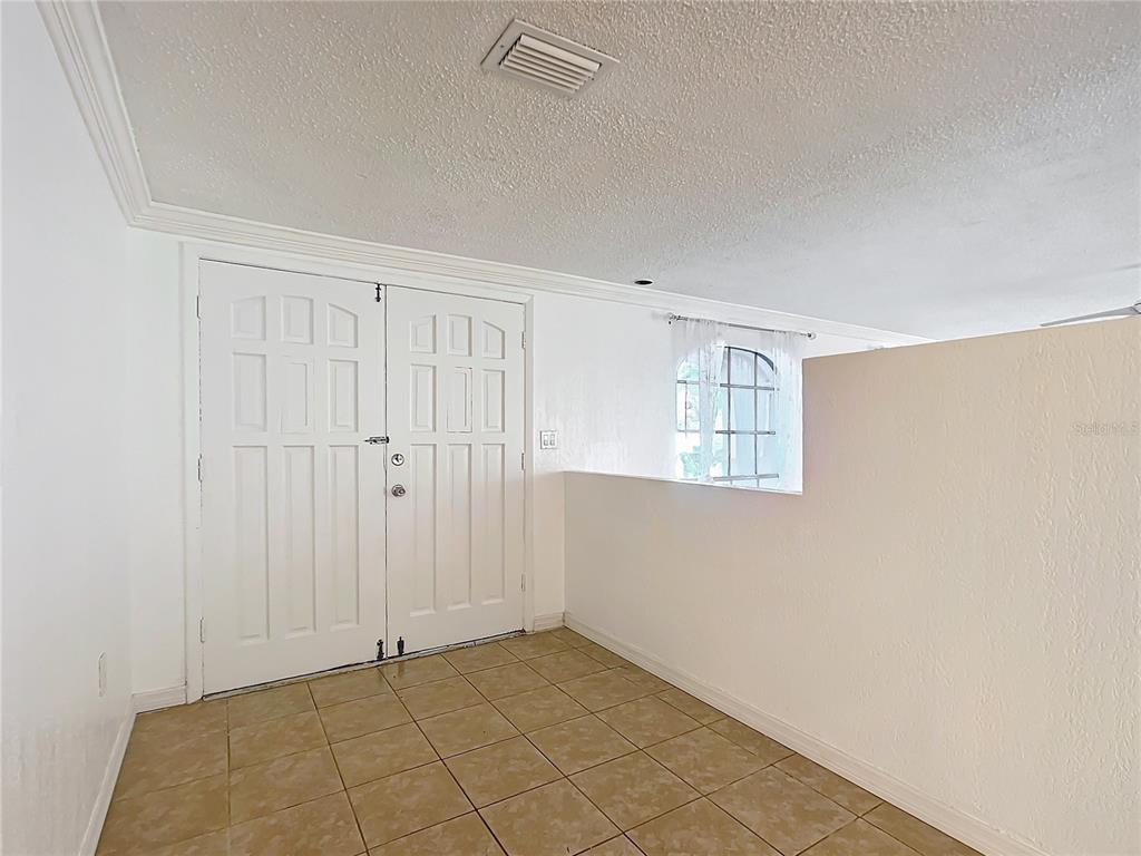 A tiled entryway features white double doors and a half-wall overlooking an adjacent space — 3640 RICHBORO DRIVE, HOLIDAY, FL