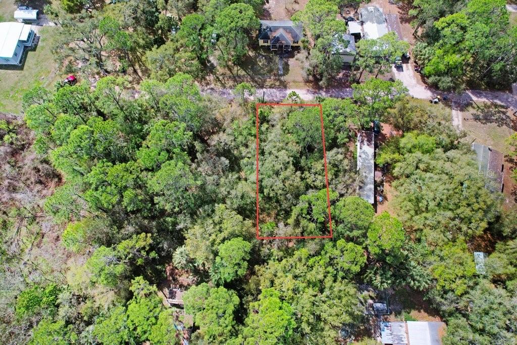 An aerial view shows a rectangular, tree-covered vacant lot outlined in red — 0 YUCATAN DRIVE, LAKE WALES, FL