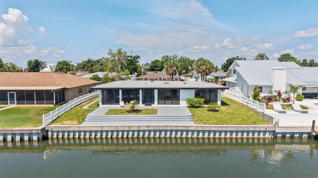 An aerial view of a waterfront house with a flat roof and a concrete patio — 3917 E EDEN ROC CIRCLE, TAMPA, FL