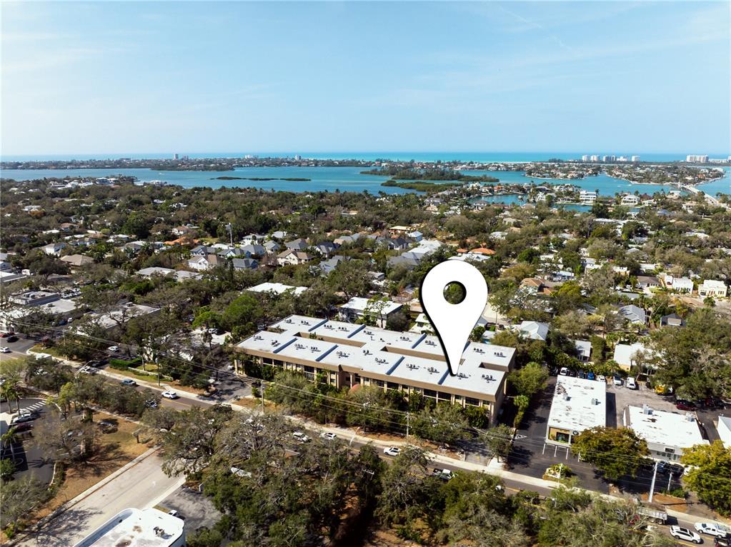 An aerial view shows a multi-story apartment building with a location pin marker — 3700 S OSPREY AVENUE UNIT 118, SARASOTA, FL