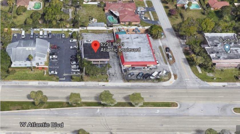 This aerial view shows a commercial building with a parking lot along a major road — 6221 W ATLANTIC BOULEVARD, MARGATE, FL