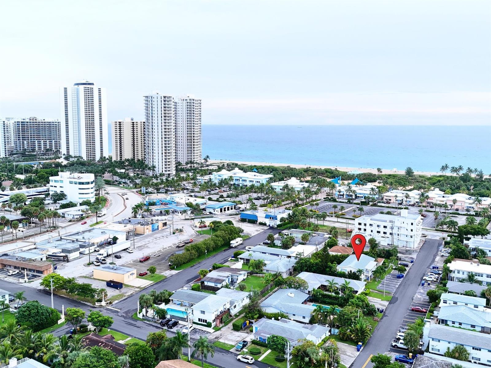 An aerial view shows a residential neighborhood near a beach with a red location pin — 1236 Beach Road # 2, Riviera Beach FL 33404, RIVIERA BEACH, FL
