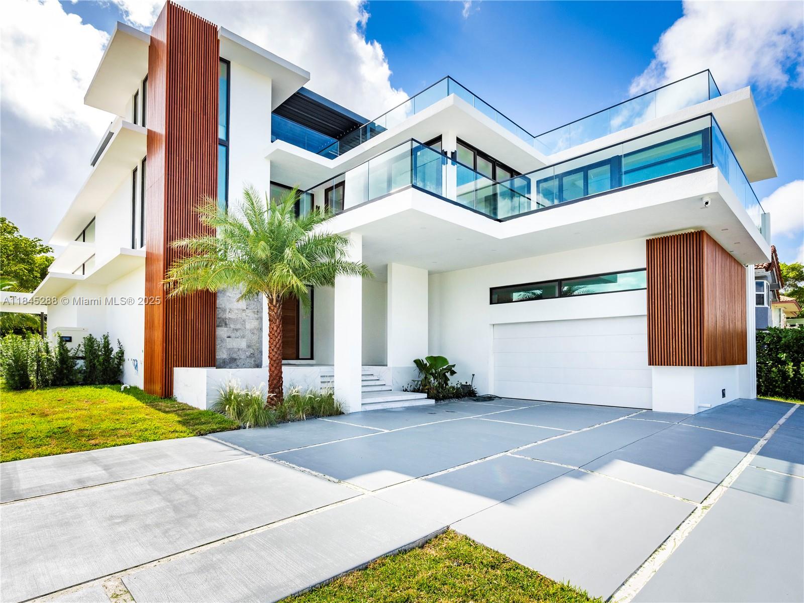A modern two-story house features white stucco, wood slat accents, a glass balcony, and a garage — 1248 NE 89th St, Miami FL 33138, MIAMI, FL