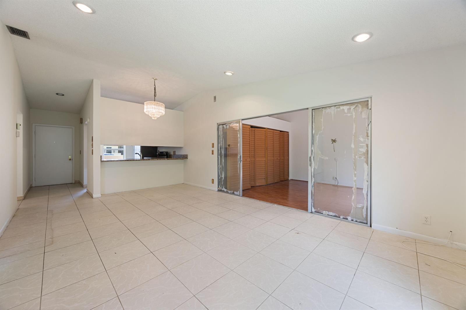 A red brick walkway leads to the front entrance of a house with a window — 5227 Copperleaf Circle, Delray Beach FL 33484, DELRAY BEACH, FL