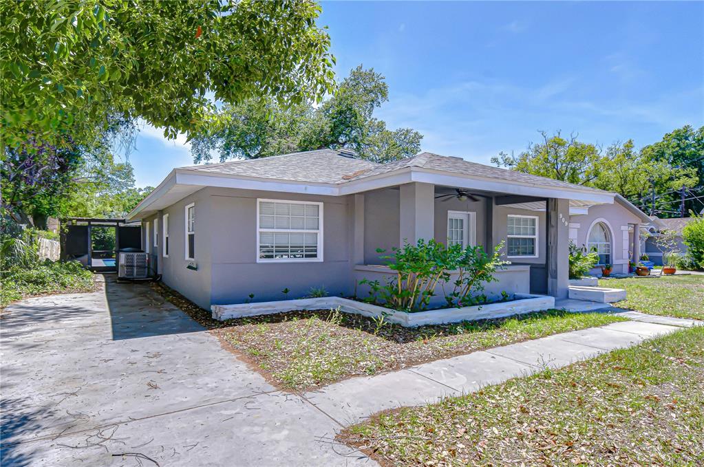 A gray single-story house with a covered front porch and a concrete driveway — 909 HART STREET, CLEARWATER, FL