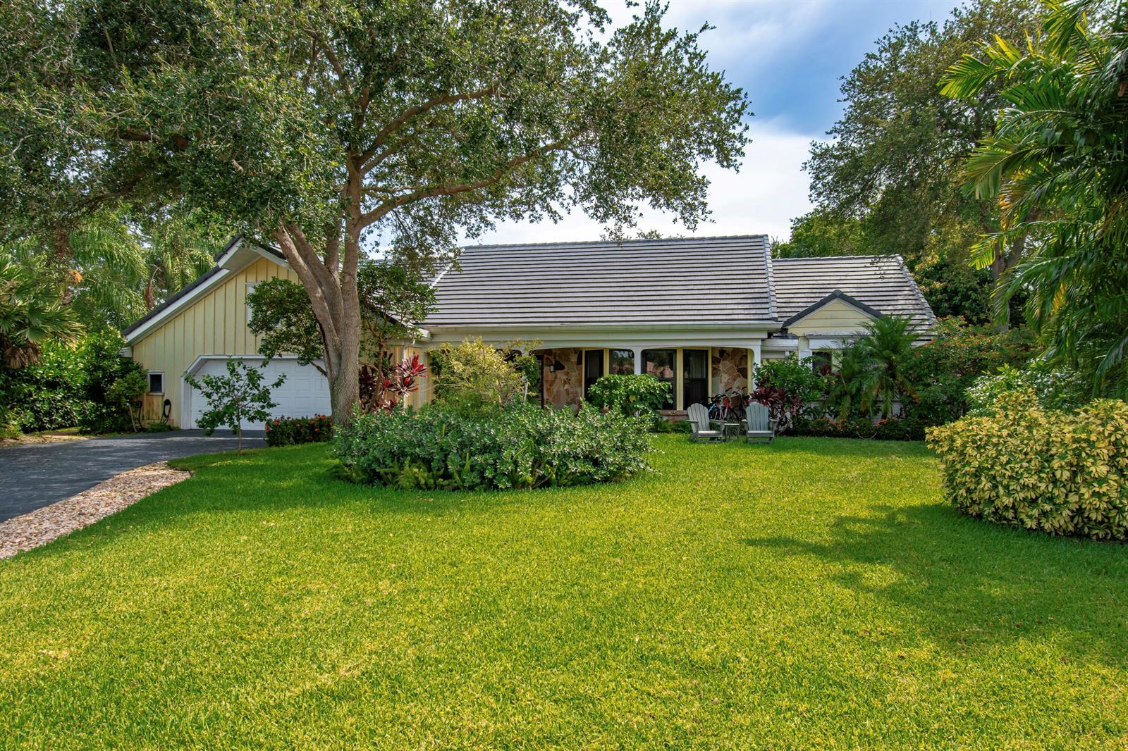 A single-story house with a yellow exterior, dark roof, and a large front lawn — 6962 S Grande Drive, Boca Raton FL 33433, BOCA RATON, FL
