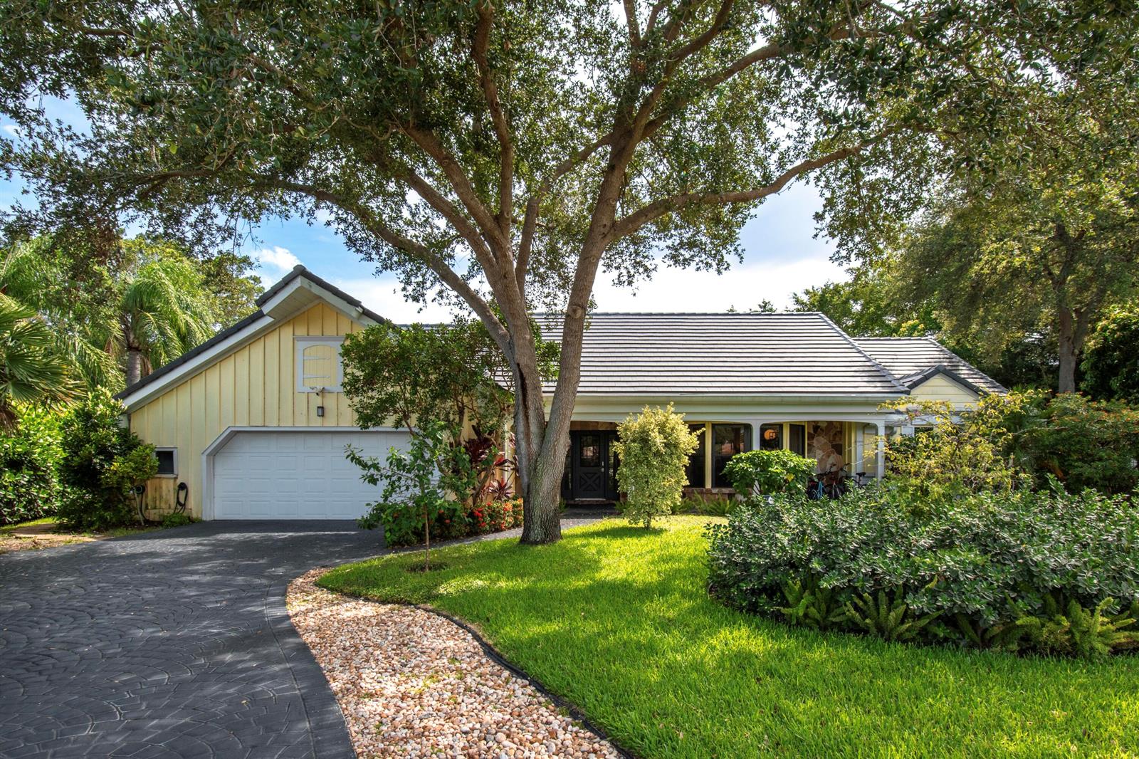A yellow house with a dark shingled roof and a curved stone driveway — 6962 S Grande Drive, Boca Raton FL 33433, BOCA RATON, FL