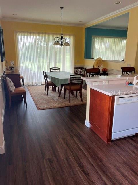 A dining area with a table and chairs sits adjacent to a kitchen counter — 3000 PINNACLE COURT, CLERMONT, FL