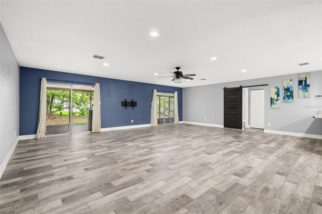 An exterior view of a single-story suburban house with a garage and a front lawn — 10702 WILLIAM TELL DRIVE, ORLANDO, FL