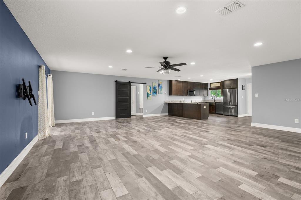 A single-story house with a tiled roof, a garage, and a large front lawn — 10702 WILLIAM TELL DRIVE, ORLANDO, FL