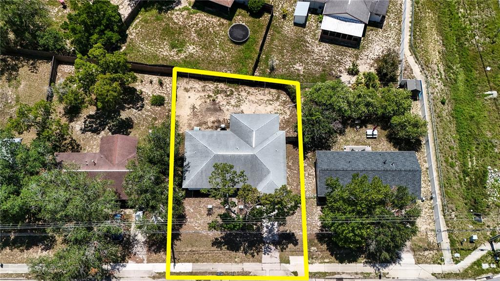 An aerial view shows a house with a gray roof outlined in yellow — 5392 MARINER BOULEVARD, SPRING HILL, FL