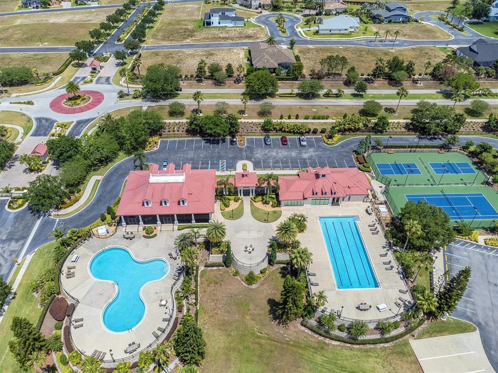 An aerial view shows a community clubhouse with two swimming pools and two tennis courts — 171 BLAZING STAR AVENUE, LAKE ALFRED, FL