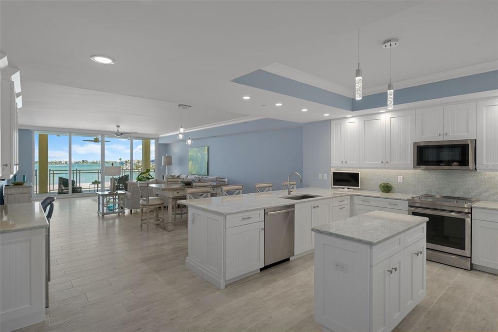 A covered balcony features tiled flooring, wicker furniture, and a view of the beach — 650 COLLANY ROAD UNIT 405, TIERRA VERDE, FL
