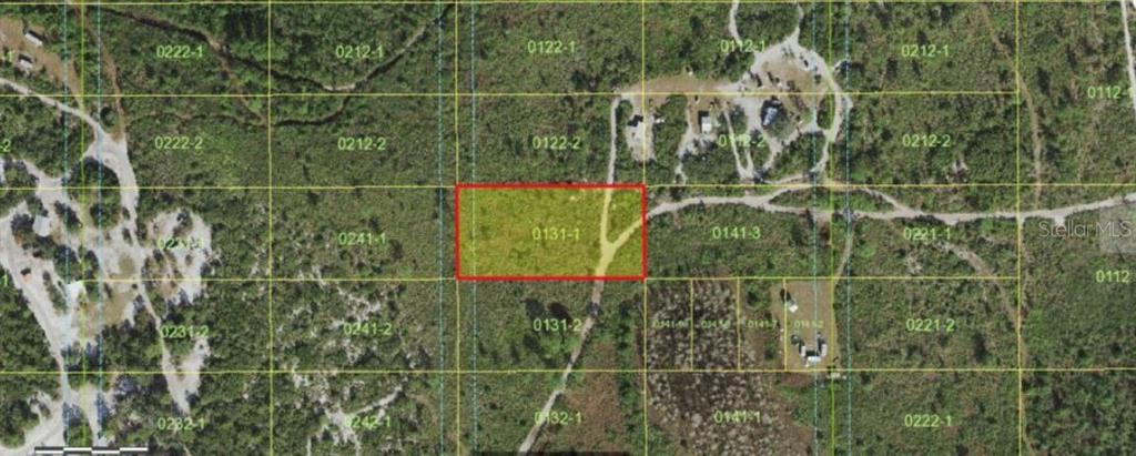 This is an aerial map showing a rectangular parcel of land highlighted in red — HOLOPAW GROVES ROAD, ST CLOUD, FL