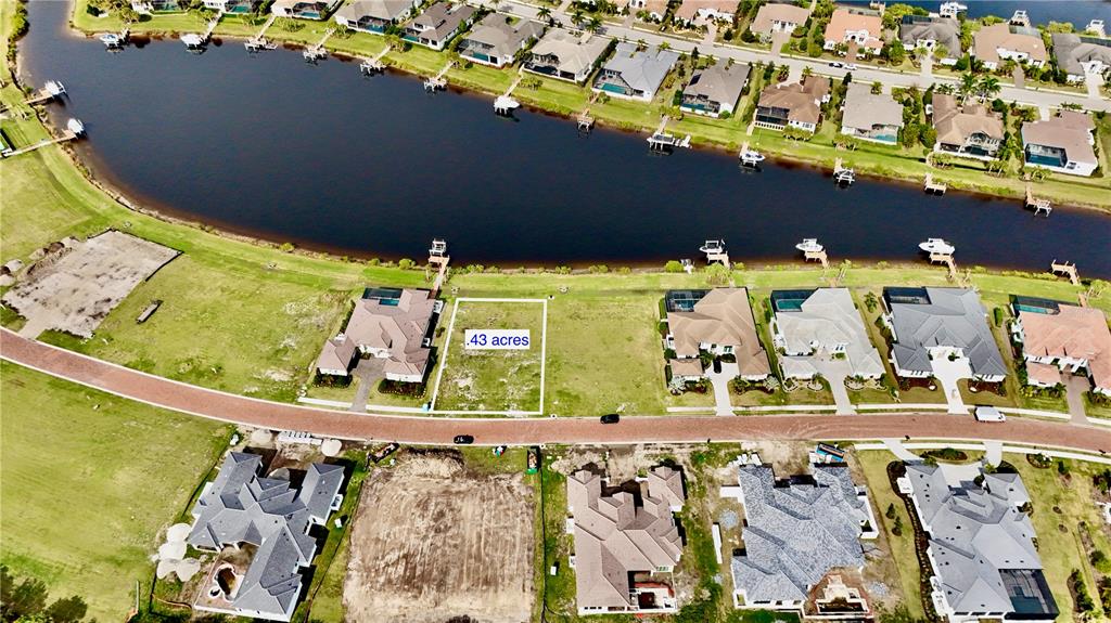 An aerial view shows a vacant residential lot marked as .43 acres near a canal — 1707 RIO VISTA TERRACE, PARRISH, FL