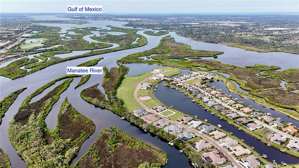 An aerial view shows a residential neighborhood situated along the winding Manatee River — 1707 RIO VISTA TERRACE, PARRISH, FL