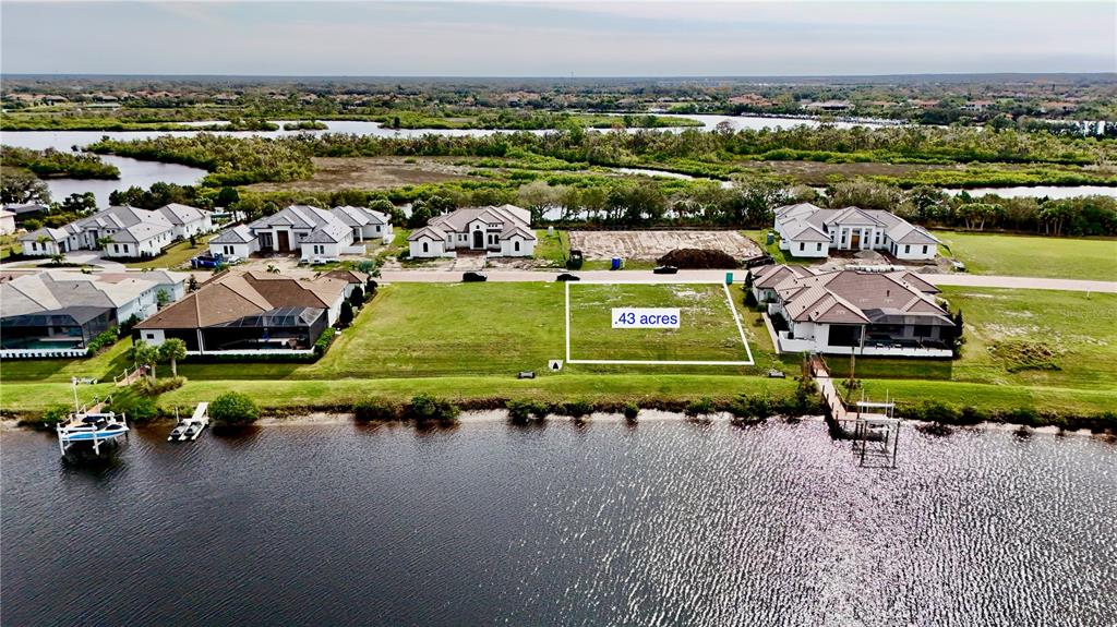 An aerial view shows a vacant waterfront lot marked as .43 acres in a residential neighborhood — 1707 RIO VISTA TERRACE, PARRISH, FL