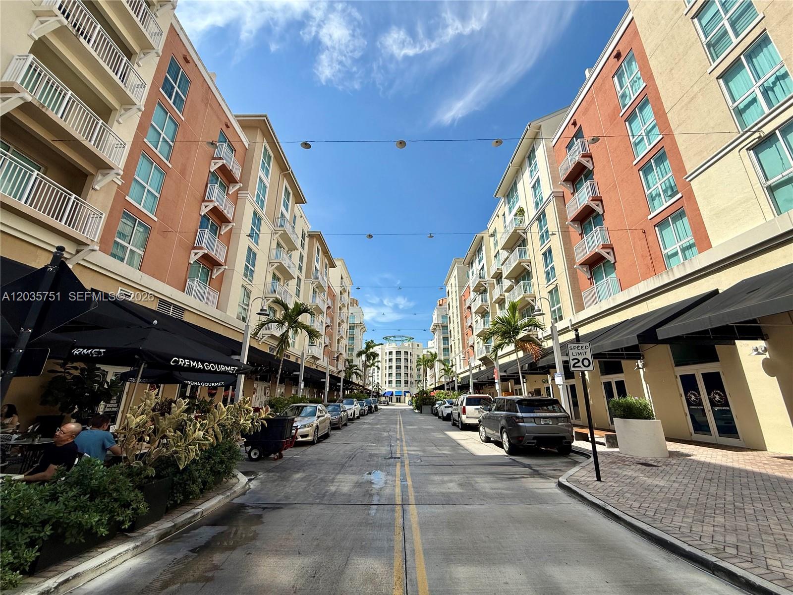 A street view shows a narrow road lined with multi-story apartment buildings and storefronts — 7275 SW 90th St # C313, Miami FL 33156, MIAMI, FL