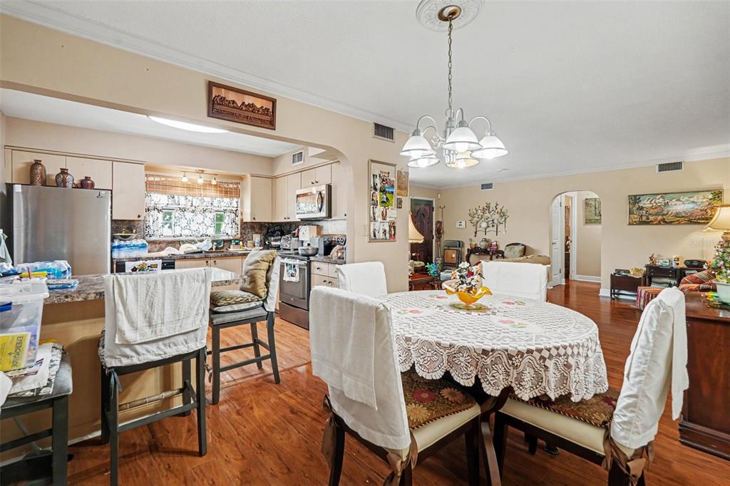 A single-story house with a gray garage, a concrete driveway, and a large tree — 8948 108TH STREET N, SEMINOLE, FL