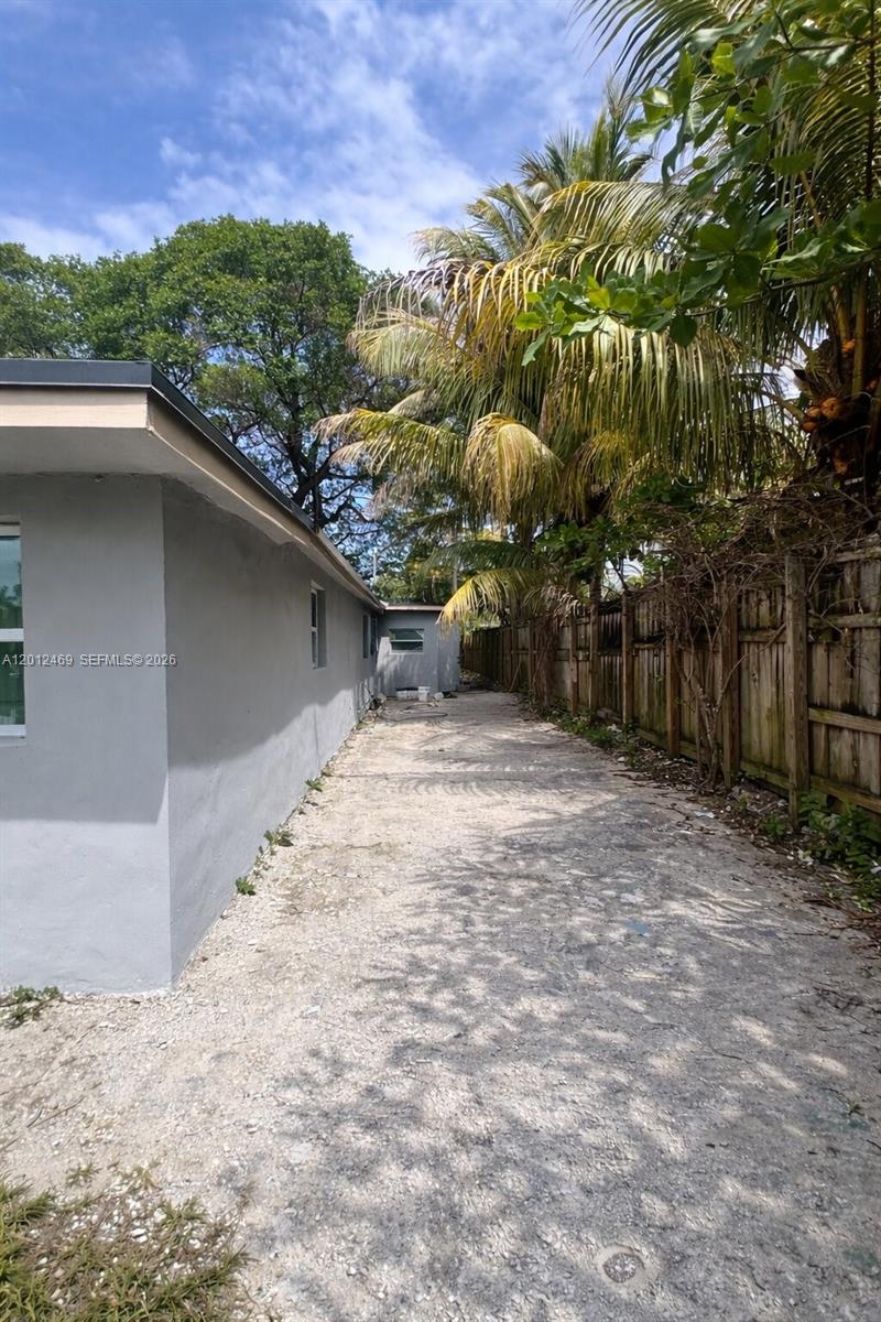 A bright, empty room features white walls, recessed lighting, and light gray tiled flooring — 1861 NW 112th St, Miami FL 33167, MIAMI, FL