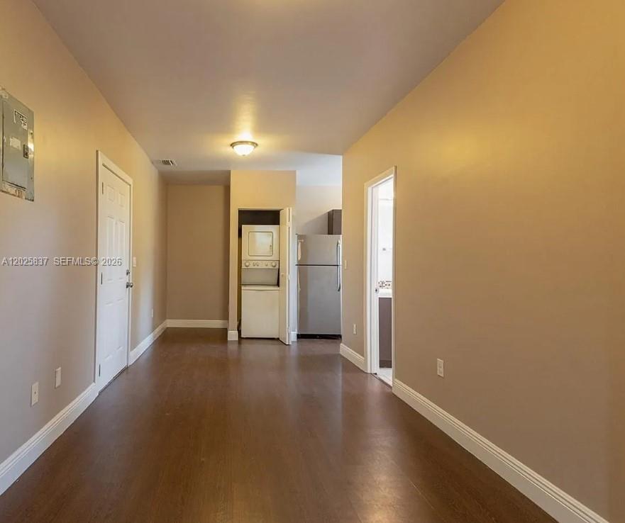A hallway leads to a kitchen area featuring a stacked washer and dryer unit — 5416 NE 1st Ct # 2, Miami FL 33137, MIAMI, FL
