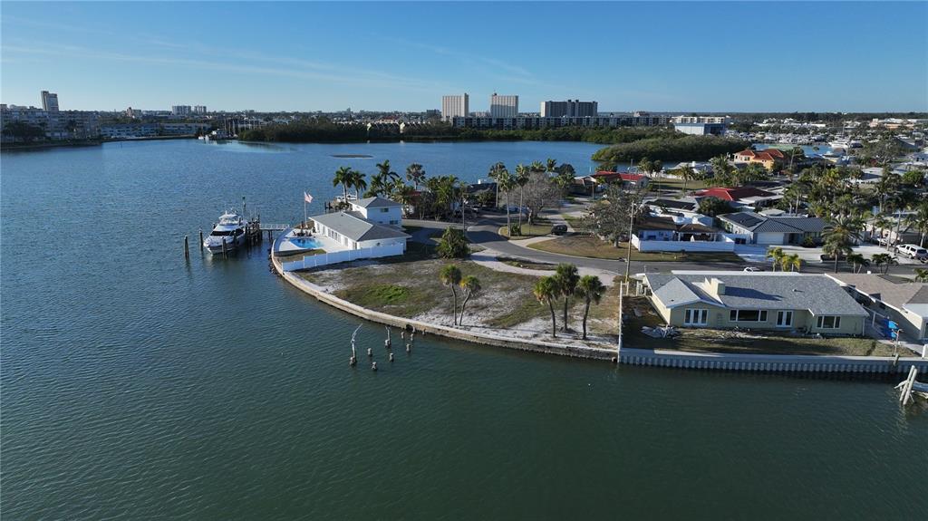 An aerial view shows a waterfront house with a pool and boat dock — 1503 SEA GULL DRIVE S, ST PETERSBURG, FL