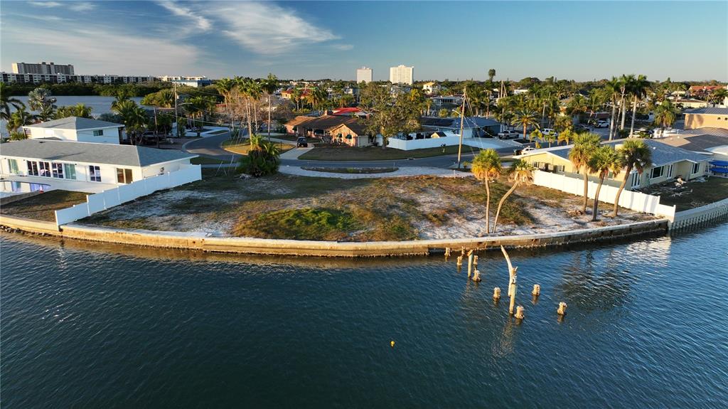 An aerial view of a vacant waterfront lot with a seawall and wooden pilings — 1503 SEA GULL DRIVE S, ST PETERSBURG, FL
