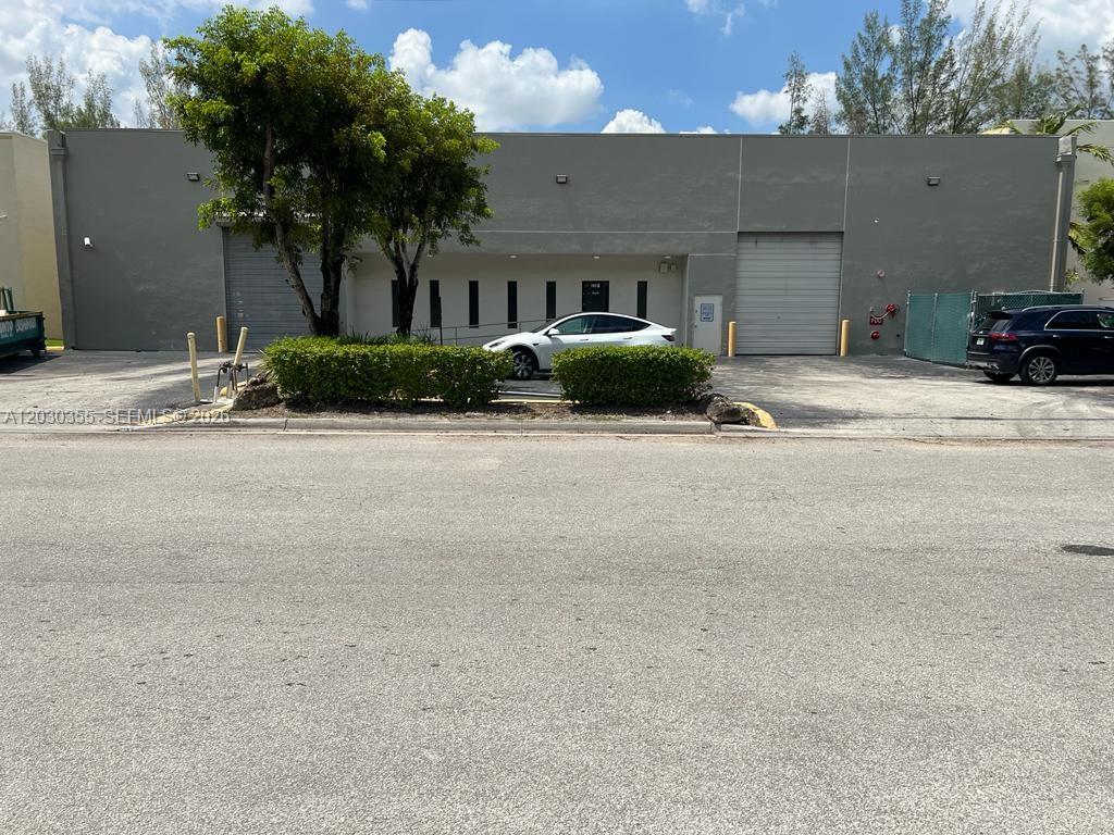 A single-story commercial warehouse building features two roll-up doors and a central pedestrian entrance — 2281 NW 95th Ave, Doral FL 33172, DORAL, FL