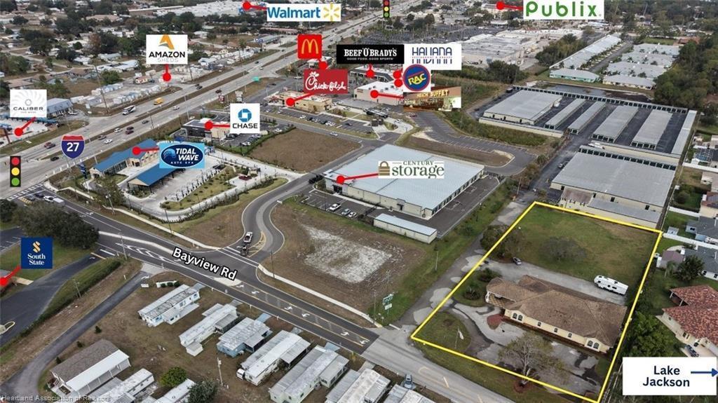 This aerial view shows a commercial area with a highlighted property near Lake Jackson — 2605 Bayview Street # 2605, Sebring FL 33870, SEBRING, FL
