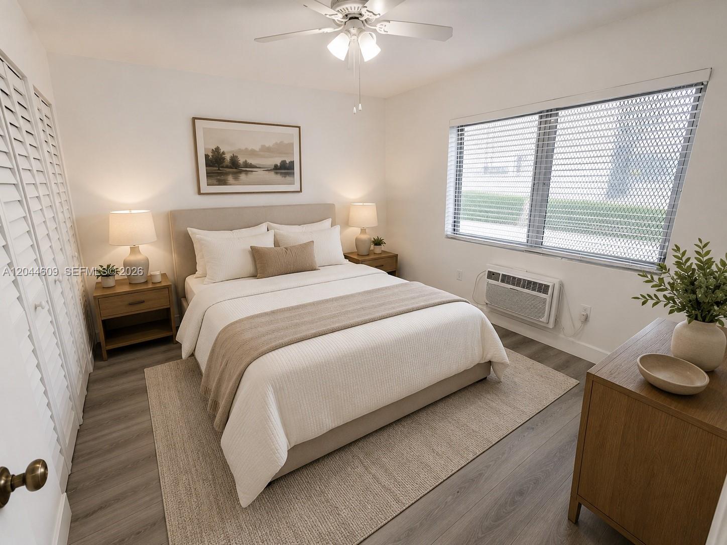 A bedroom features a queen bed, wood-look flooring, a ceiling fan, and a window unit — 34 Madeira Ave # 3, Coral Gables FL 33134, CORAL GABLES, FL