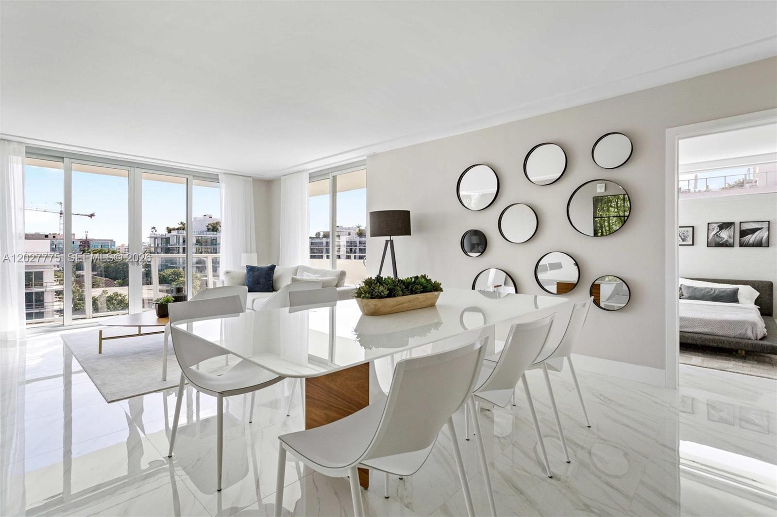 A bright dining room features a white table, modern chairs, and a wall of mirrors — 1150 101st ST # 603, Bay Harbor Islands FL 33154, BAY HARBOR ISLANDS, FL