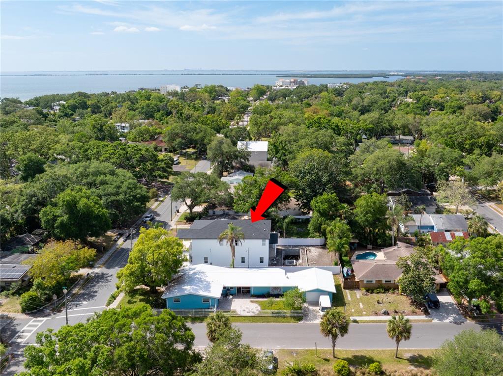 An aerial view shows a white two-story house with a black roof and a pool — 685 1ST AVENUE N, SAFETY HARBOR, FL